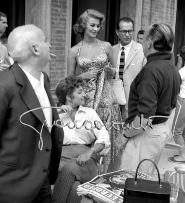Venice International Film Festival - Actress Sophia Loren (up) speaking with Angelo Rizzoli (right). Venice, 1955